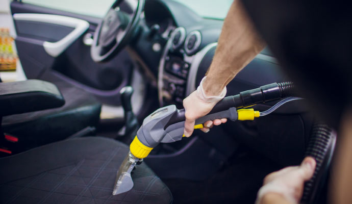 A professional cleaning a vehicle