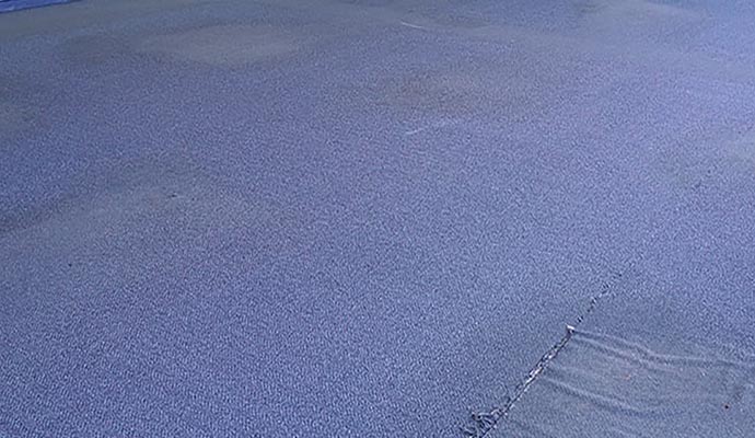 Close-up view of a damaged carpet