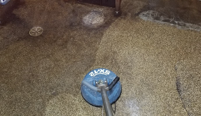 professional worker cleaning stone floor