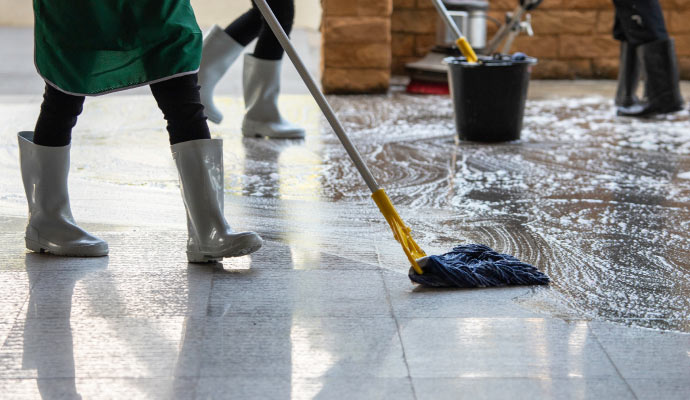 professional cleaner mopping commercial floor