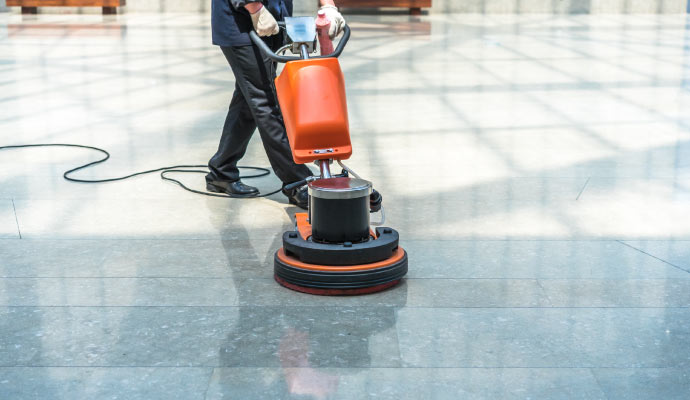 professional worker cleaning commercial floor