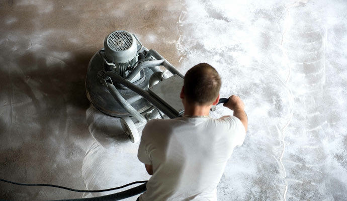 professional worker cleaning concrete floor