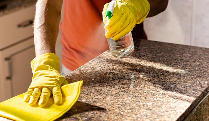 Person cleaning a countertop