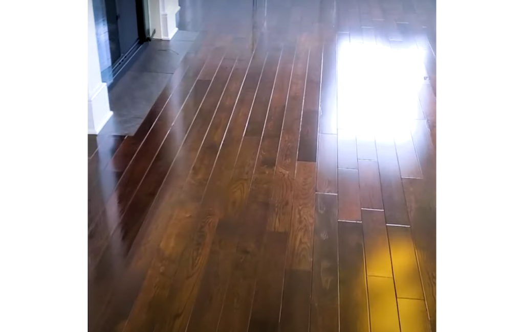 Image of Hardwood floors cleaned by a professional with a machine and cleaning solution