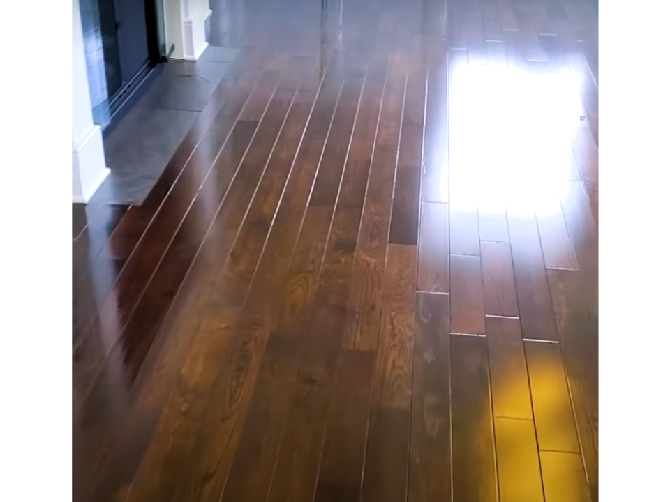 Image of Hardwood floors cleaned by a professional with a machine and cleaning solution